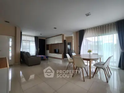 Spacious modern living room with elegant dining area and abundant natural light.