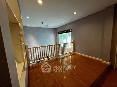 Spacious open loft area with wooden flooring and modern lighting, perfect for a cozy living space.