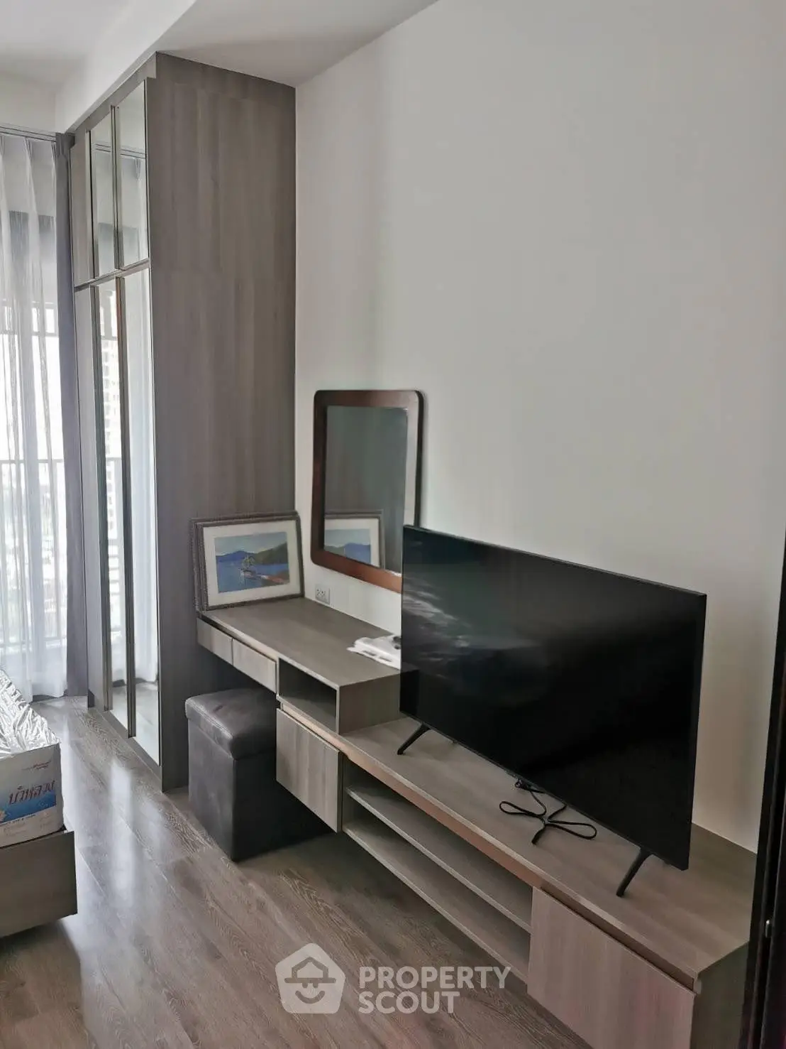Modern living room with sleek TV stand and large window for natural light