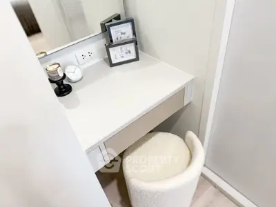Cozy study nook with modern desk and plush stool in stylish apartment