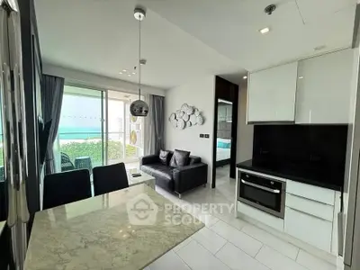 Modern open-layout kitchen and living room with ocean view balcony