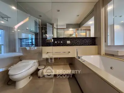 Luxurious modern bathroom with glass walls and elegant fixtures