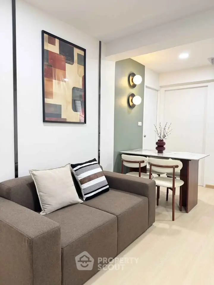 Modern living room with stylish decor and cozy dining area in a contemporary apartment.