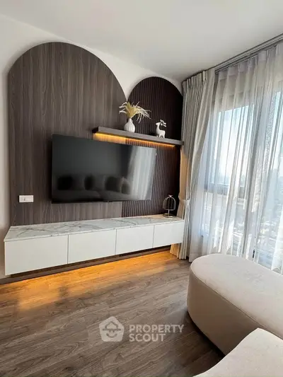 Modern living room with stylish TV setup and large window view