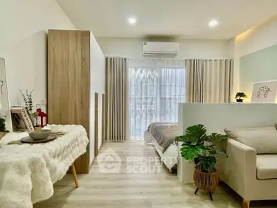 Modern studio apartment with cozy living area and stylish decor