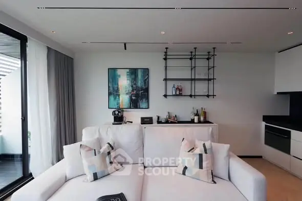 Modern living room with sleek design and balcony view, featuring stylish furniture and contemporary decor.