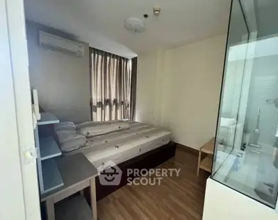 Cozy bedroom with wooden flooring and natural light