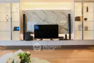 Luxurious living room with modern entertainment center and elegant marble backdrop.