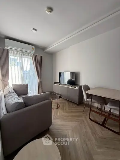 Modern living room with stylish furniture and natural light, perfect for relaxation and entertainment.