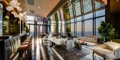 Luxurious penthouse living room with panoramic city views and modern decor.