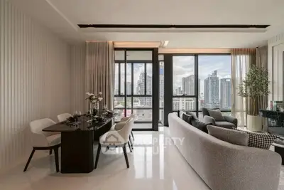Luxurious modern living room with city view, elegant dining area, and stylish decor.