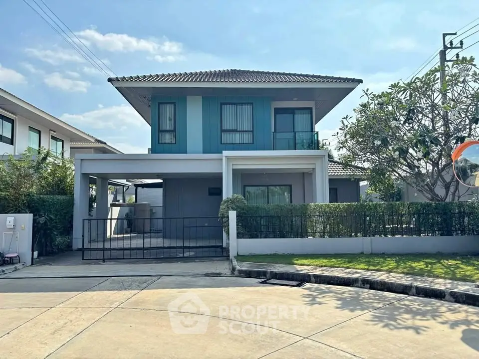 Modern two-story house with a spacious driveway and lush greenery in a serene neighborhood.