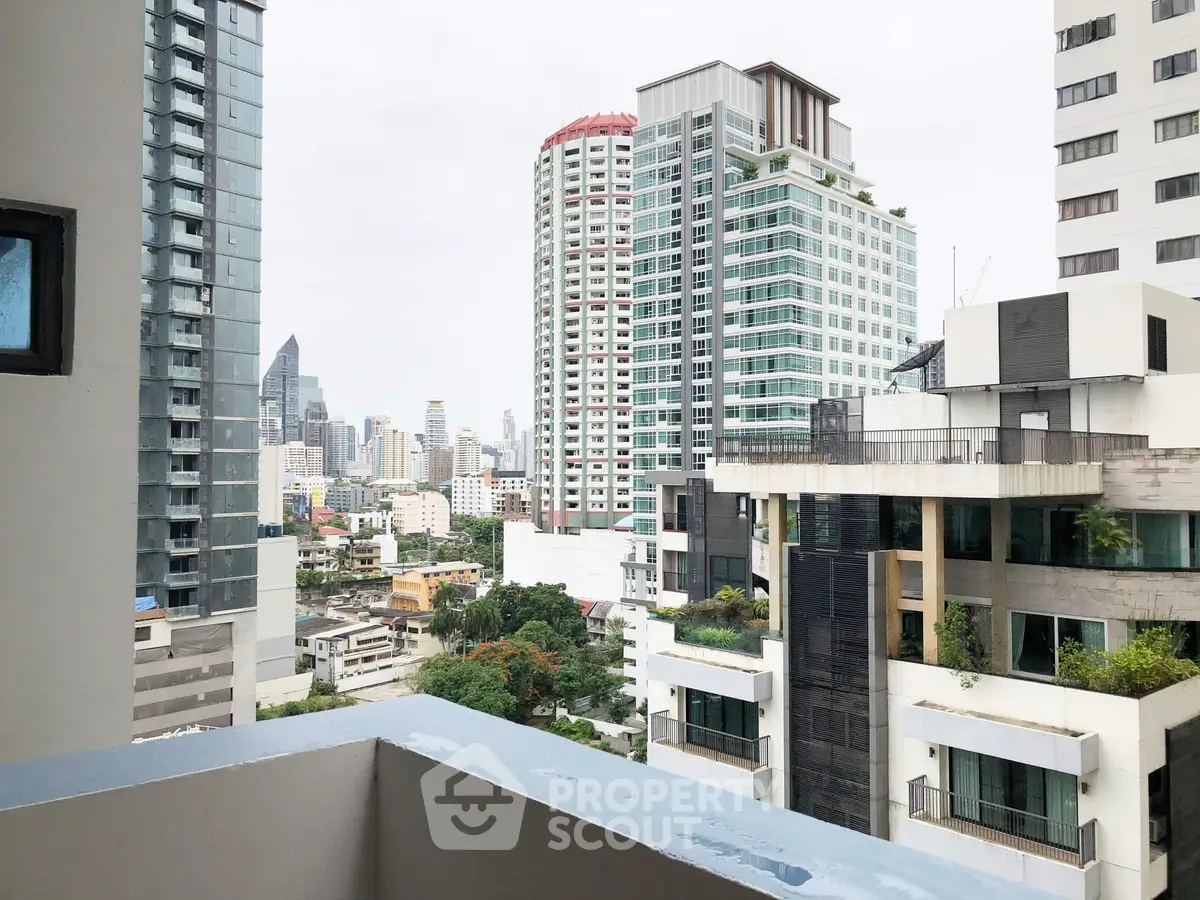 Stunning cityscape view from a modern balcony in a high-rise building.