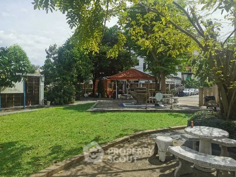 Charming garden view with lush greenery and cozy seating area, perfect for relaxation and outdoor gatherings.