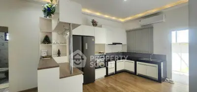 Modern kitchen with sleek cabinetry, built-in oven, and stylish decor in a bright, airy space.