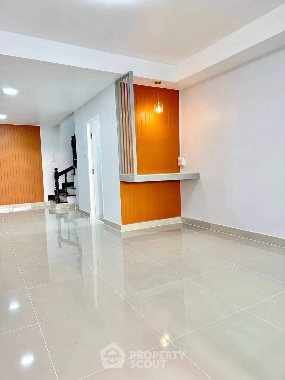 Modern interior with sleek staircase and stylish lighting in open layout