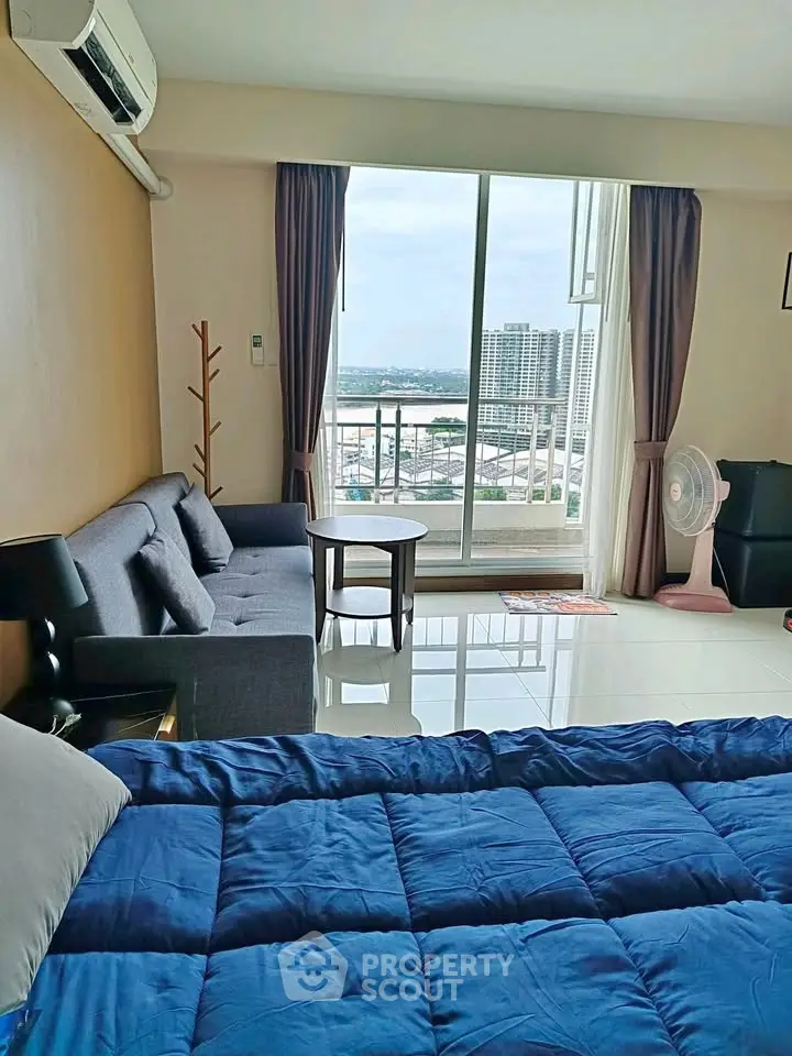 Spacious bedroom with balcony view in modern apartment