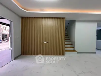 Modern interior with sleek staircase and stylish wall paneling in a contemporary home.