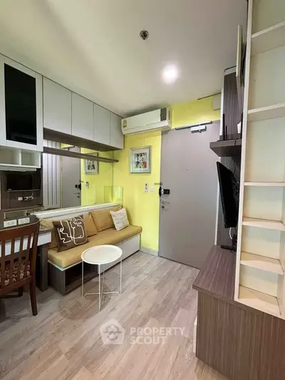 Charming compact living room with modern decor and cozy seating area, perfect for urban living.