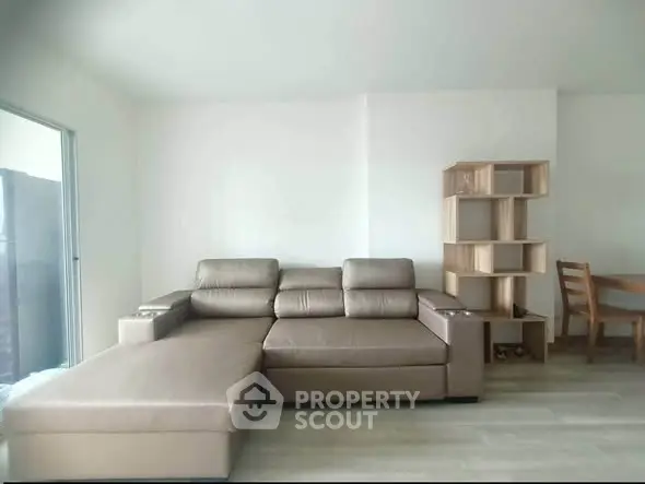 Spacious living room with modern leather sofa and stylish wooden furniture