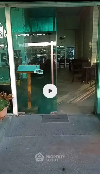 Closed restaurant entrance with glass doors and interior view