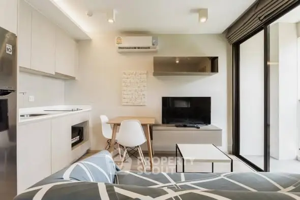 Modern living room with open kitchen and balcony access