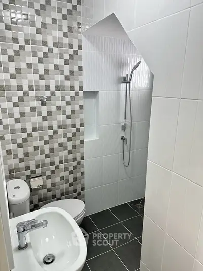 Modern bathroom with stylish tiles and sleek fixtures in a contemporary apartment.