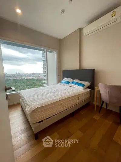 Modern bedroom with stunning city view and cozy furnishings