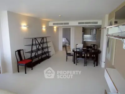 Spacious modern living room with dining area and sleek shelving, perfect for contemporary living.