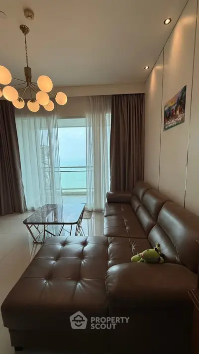 Luxurious living room with leather sofa and ocean view balcony
