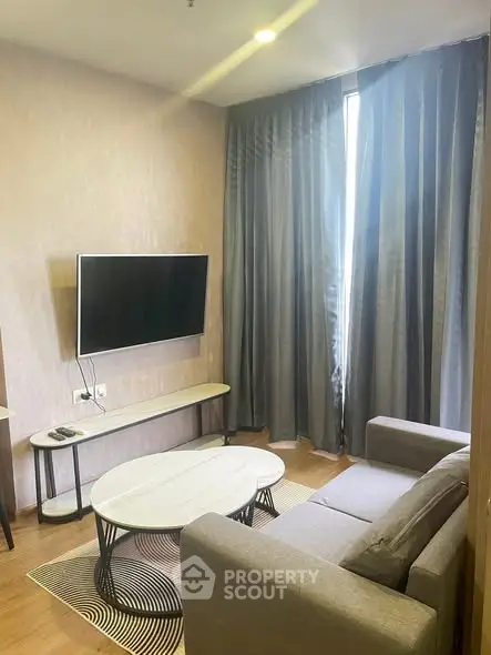 Modern living room with sleek furniture and wall-mounted TV, perfect for cozy relaxation.