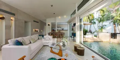 Luxurious open-plan living room with pool view and modern decor