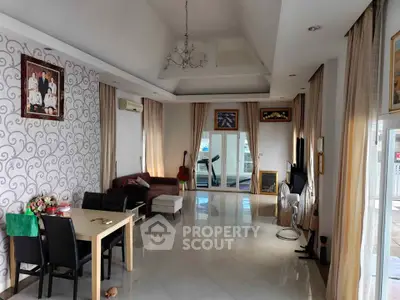 Spacious living room with elegant decor and large windows offering ample natural light.