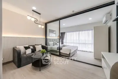 Modern open-plan living room with stylish decor and bedroom view