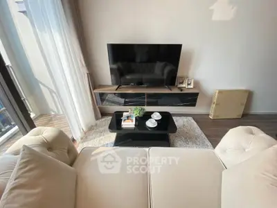 Modern living room with stylish furniture and large TV, perfect for relaxation and entertainment.