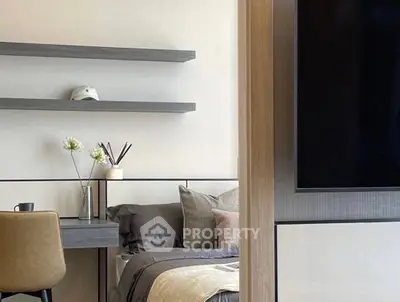 Modern bedroom with stylish decor and workspace, featuring sleek shelves and cozy bedding.