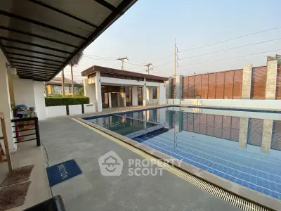 Luxurious outdoor pool area with modern design and spacious deck, perfect for relaxation and entertainment.