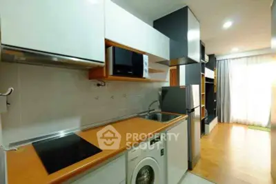 Modern kitchen with sleek appliances and open layout in a stylish apartment.
