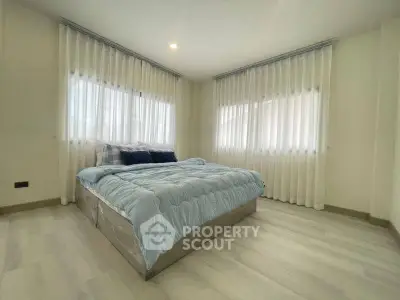 Spacious bedroom with large windows and modern decor