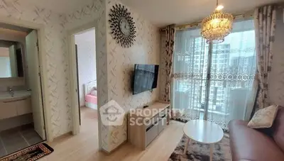 Chic living room with modern decor and city view, featuring a wall-mounted TV and elegant chandelier.