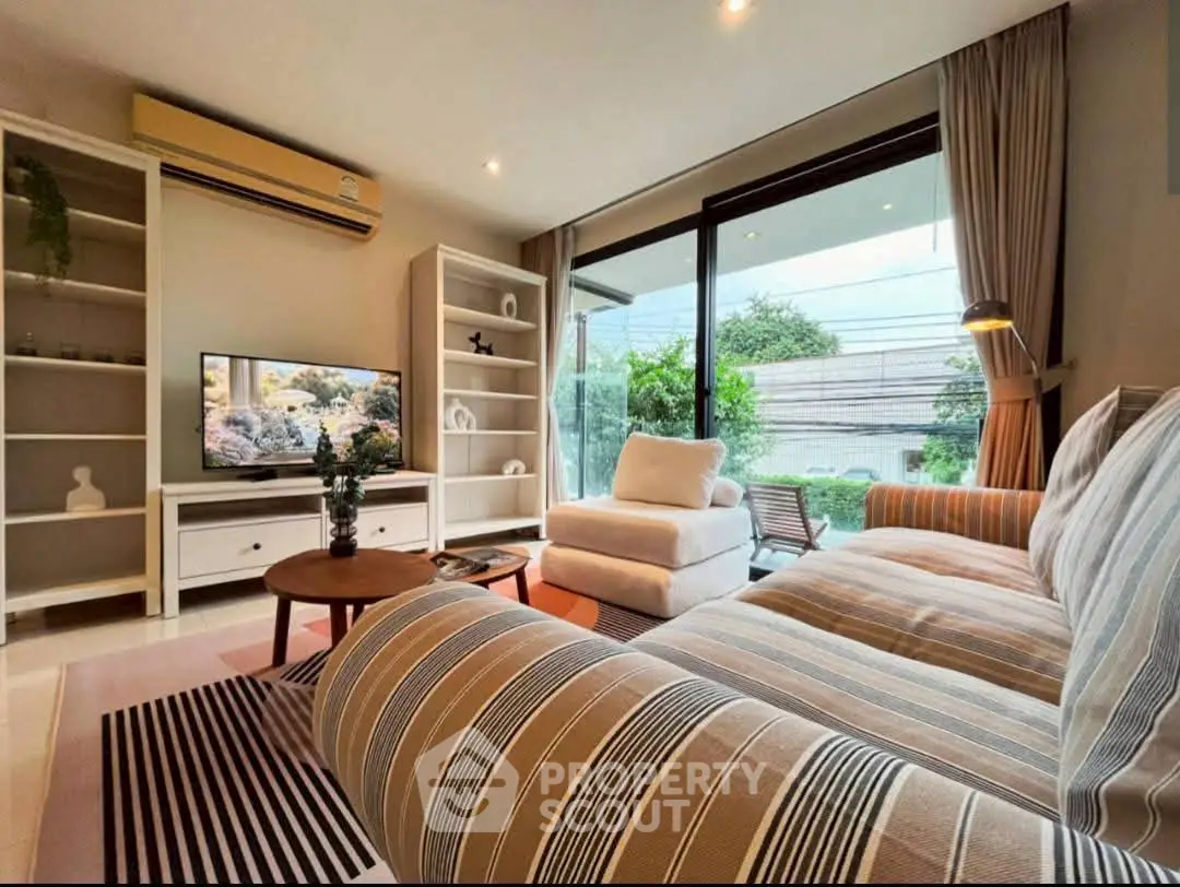 Spacious living room with modern decor and large window view