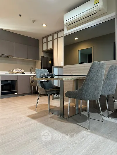 Modern kitchen with sleek dining area and built-in appliances