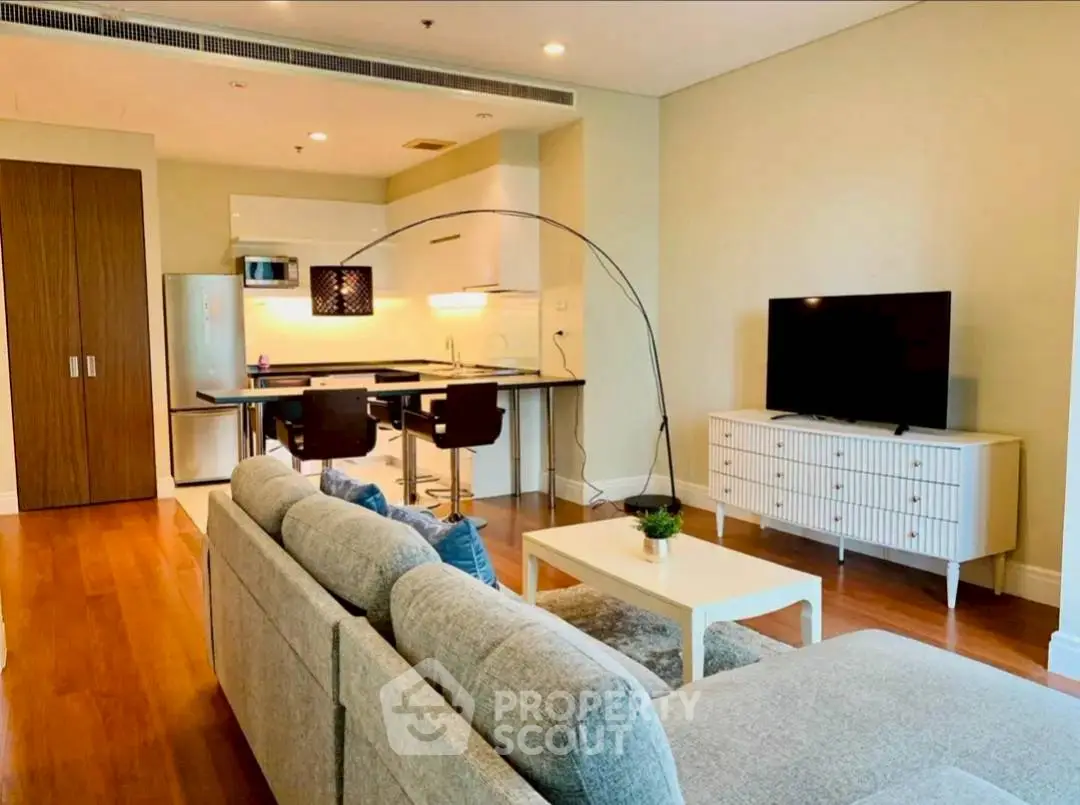 Modern open-plan living room with sleek kitchen and stylish furniture