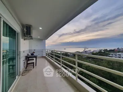 Spacious balcony with stunning ocean view at sunset, perfect for relaxation and enjoying the scenery.