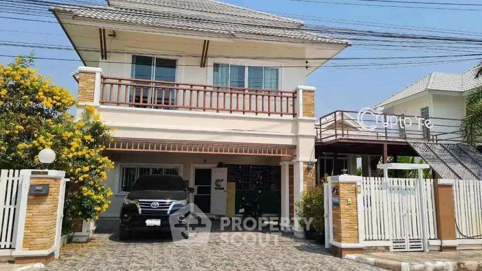 Charming two-story house with carport and lush garden in a serene neighborhood.