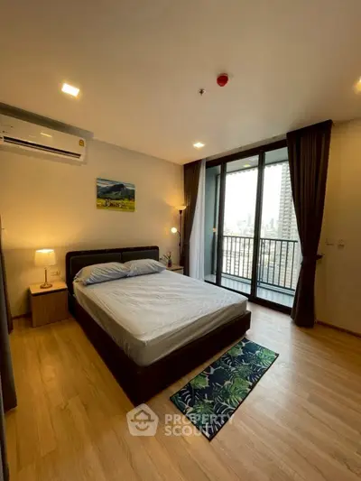 Spacious bedroom with balcony view in modern apartment