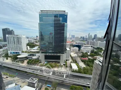 Stunning cityscape view from high-rise building window showcasing urban architecture.