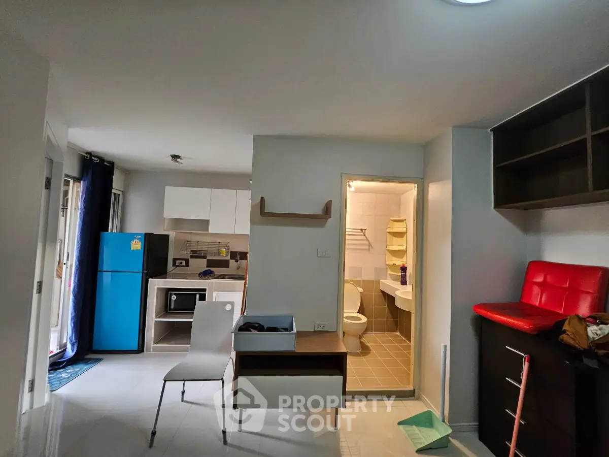Modern apartment interior with kitchen and bathroom, featuring sleek appliances and contemporary design.