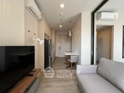 Modern living room with sleek furniture and open kitchen layout