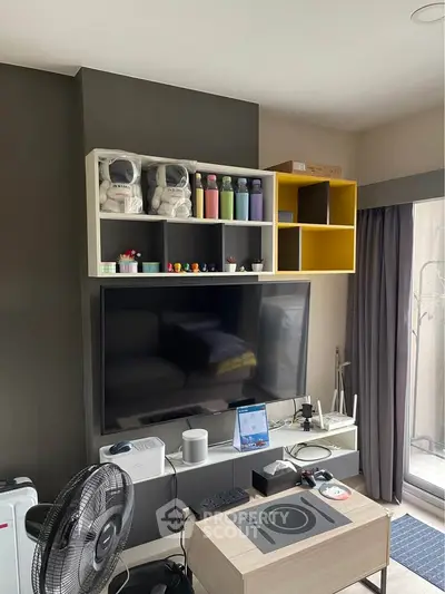 Modern living room with wall-mounted TV, stylish shelving, and contemporary decor.